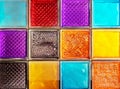 Colored glass blocks with embossed patterns. Multi-colored glass squares Royalty Free Stock Photo