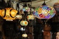 Colored glass lamps for sale at a market stall