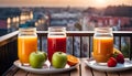 Colored glasses, jars of fruit juice and plates with healthy snacks located on the balcony, healthy eating concept,