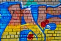 Colored graffiti on a brick wall