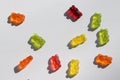 Colored gummy bears on white background. Multicolored jelly candy pattern