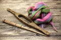 Colored hair and old spindle close-up on wooden background. Tools for knitting of wool