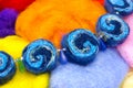 Colored handmade beads. Handmade necklace made of dry natural merino bright colorful wool beads, felt dried balls. Blue, orange, w Royalty Free Stock Photo