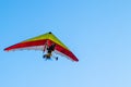 Colored Hang glider flying in the blue sky
