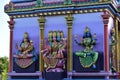 Colored hindu divinities on the facade of a temple.