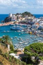 Colored houses, boats, ferry in the harbor of island of Ponza. Italy