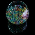 Colored hydrogel balls in a glass vase on a black background Royalty Free Stock Photo