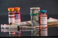 colored jars of coronavirus vaccine stand on the table.