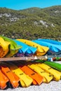 Colored kayak canoes on the sea beach. Summer holidays and activities on the water. Vacation, relax, sport concept. Royalty Free Stock Photo