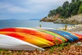 Colored Kayaks on the Shore of a Summer Bay Royalty Free Stock Photo