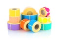 Colored label rolls on white background with shadow reflection. Color reels of labels for printers.