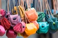 Colored leather moneybags hanging at laces