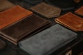 Colored leather passport covers and wallets on the table. Black background. Handmade concept. Royalty Free Stock Photo