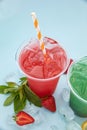 Colored lemonades in plastic cups with ice, fruits and berries