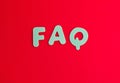 Colored letters as FAQ abbreviation frequently asked questions on red background with copy space