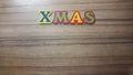 colored letters form the word Xmas on wooden background