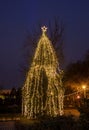 Colored lighted Christmas tree with ornaments, outdoor night time Royalty Free Stock Photo