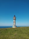 The colored lighthouse on an afternoon in spring Cantabria