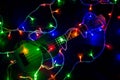 Colored lights of garlands and ukulele close-up