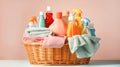 Colored linen towels in a wicker basket, various detergents for washing on a pastel background