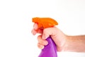 Colored liquid pulverizer held by Caucasian male hand close up shot isolated against white