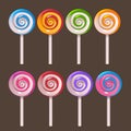 Colored lollipops on stick set on dark background