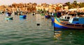 Colored luzzu fishing boats in the port of Marsaxlokk on the Island of Malta Royalty Free Stock Photo