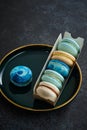 Colored macaroons on a dark background. Copy space.