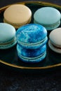 Colored macaroons on a dark background. Copy space.