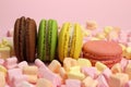 Colored macaroons or macarons, marshmallow hearts on a pink background Royalty Free Stock Photo