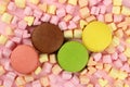 Colored macaroons or macarons, marshmallow hearts on a pink background Royalty Free Stock Photo