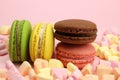 Colored macaroons or macarons, marshmallow hearts on a pink background Royalty Free Stock Photo