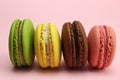 Colored macaroons or macarons on a pink background Royalty Free Stock Photo