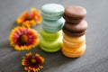 Colored macaroons stand upright on the table.