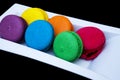 Colored macaroons on a white plate Royalty Free Stock Photo