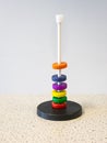 Colored magnetic rings around a rod float above each other