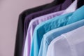 Colored men`s shirts that hang on hangers Royalty Free Stock Photo