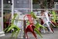 Colored metal chairs supported on the tables of a bar Royalty Free Stock Photo