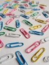 colored metalic clips, colored crayon row and note book with spiral, background and texture