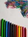 colored metalic clips and colored crayon row, background and texture