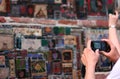 Tourist make a photo of colored mosaic on the wall of the Tbilisi Theater Rezo Gabriadze.