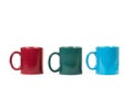 Three colored mugs isolated on a white background Royalty Free Stock Photo