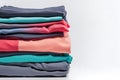 Colored multi-colored T-shirts lie in a stack