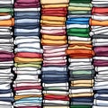 Colored multi-colored T-shirts lie in a stack. Concept of diversity in the world Royalty Free Stock Photo