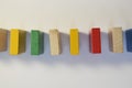 Colored, multi-colored dominoes stand in a row, exactly