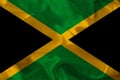 Colored national flag of the modern state of Jamaica on beautiful pleated silk fabric, concept of tourism, economic and political