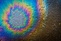 Colored oil stain on the asphalt. A rainbow slick of gasoline. Abstract background Royalty Free Stock Photo