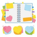 A colored open notepad on the spring with clean sheets and bookmarks between the pages. A set of sticky stickers in the form of