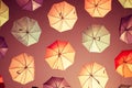 Colored open umbrellas on sky background.