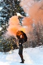 Colored orange smoke. A girl in a black dress under a black umbrella, from which orange smoke flows. Royalty Free Stock Photo